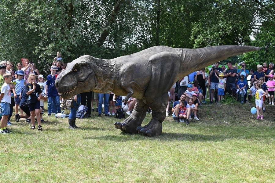Dinozaur spaceruje wśród dzieci
